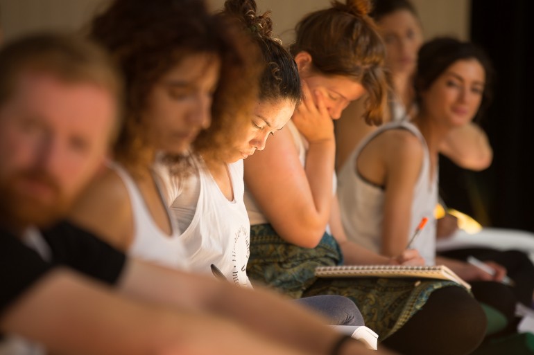 yoga students in ireland in a row making notes