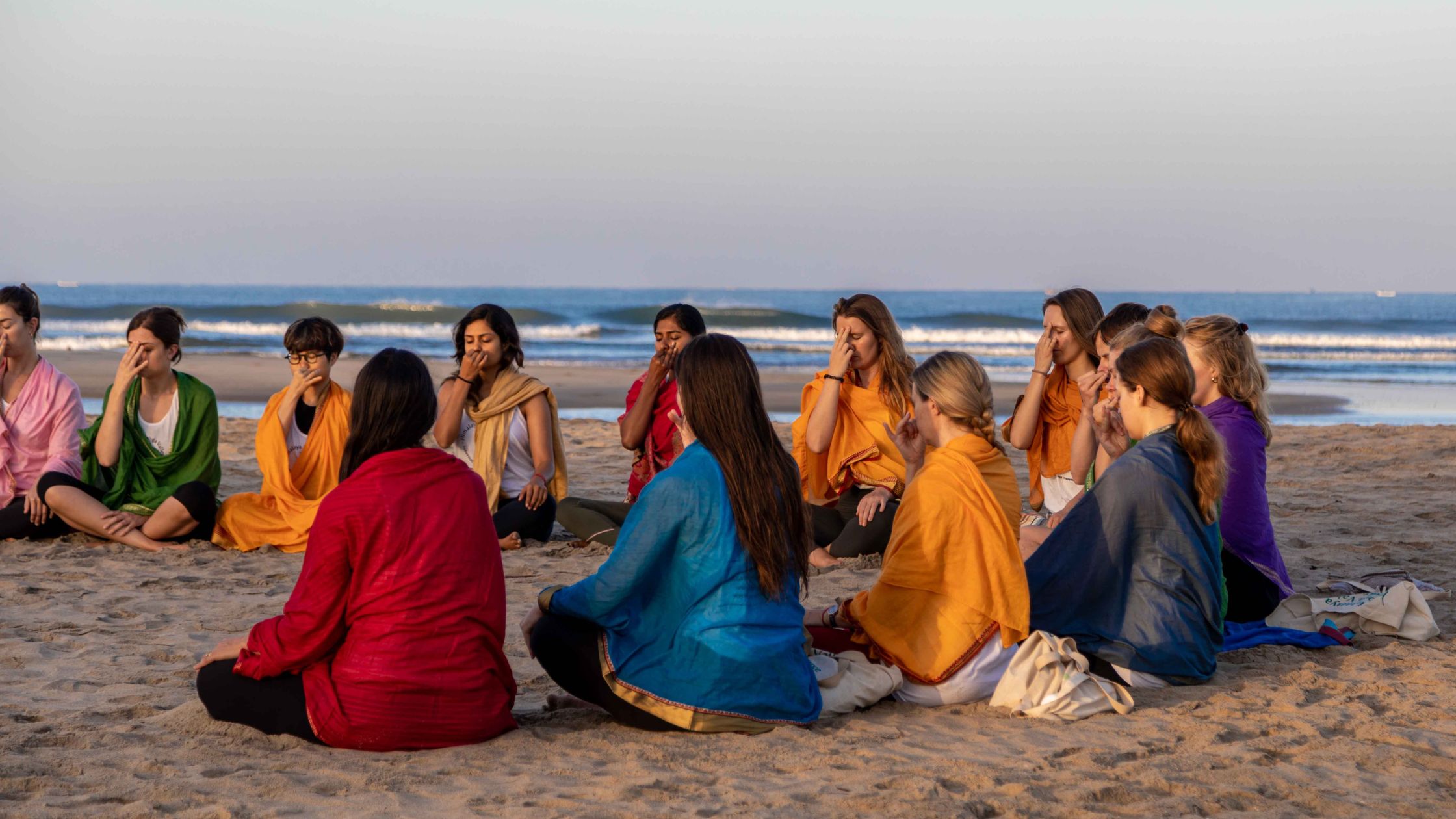 Yoga students practising asana in nature at Himalaya Yoga Valley retreat centre in Goa, India