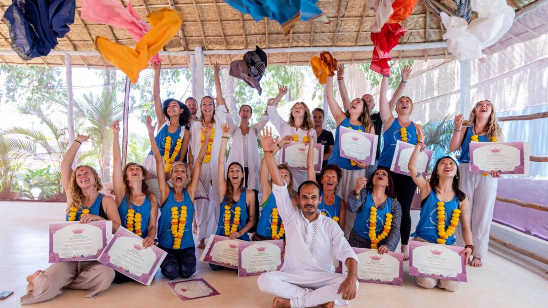 Happy 300HR yoga teacher training graduates celebrating after certification in Goa