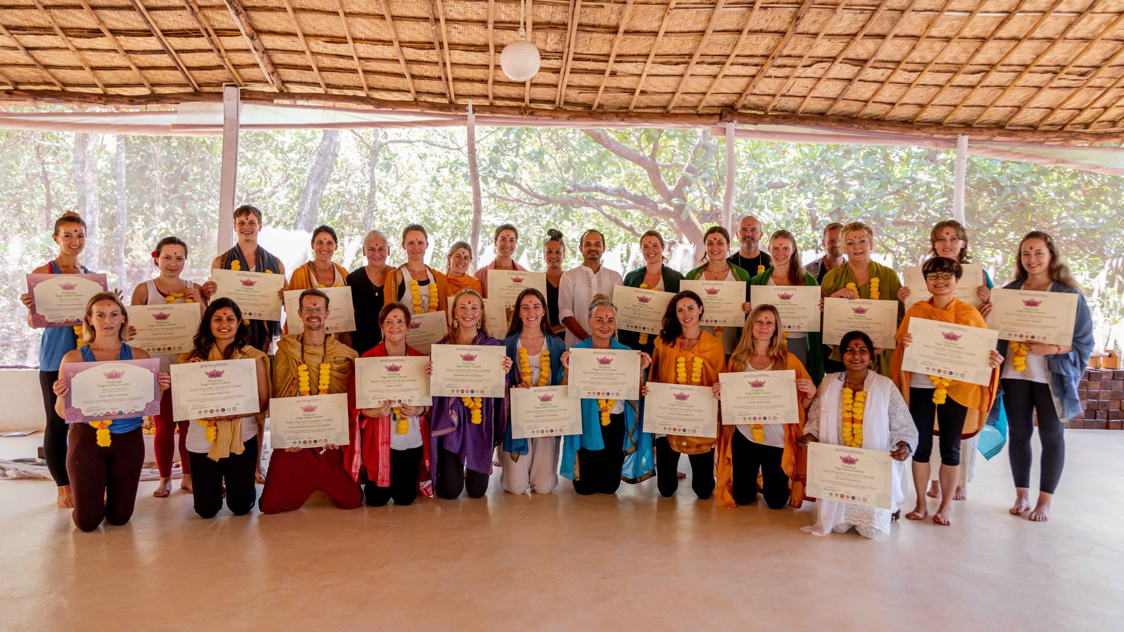 Student receiving yoga teacher training certificate at Himalaya Yoga Valley Goa