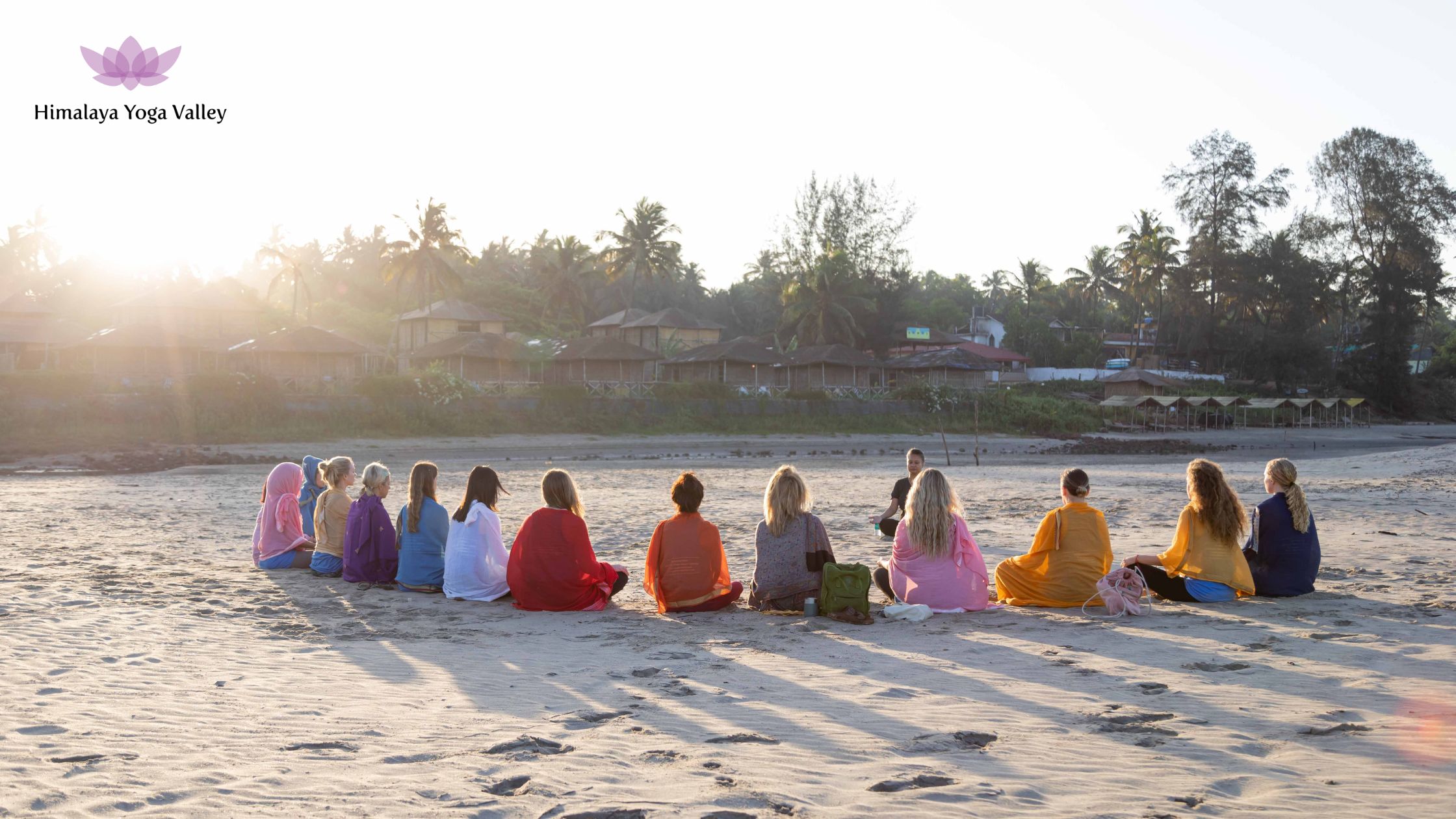 Yoga practitioner meditating at sunrise on a beach in Goa, India