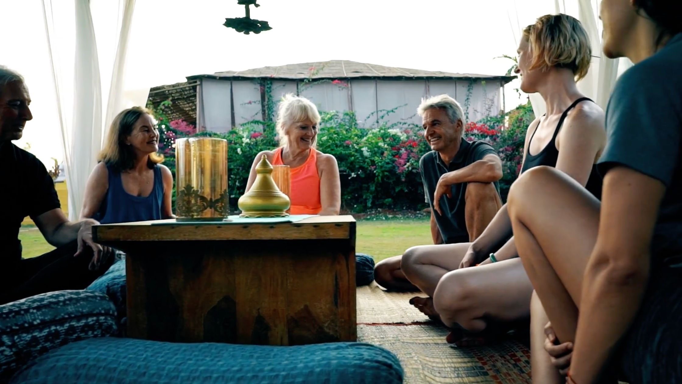 Group of yoga retreat participants sharing a meal together at Himalaya Yoga Valley centre in Goa.